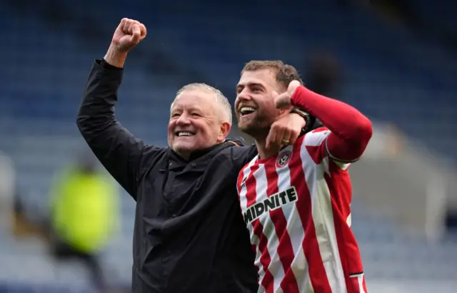 Sheffield United manager Chris Wilder celebrates the win with Patrick Bamford
