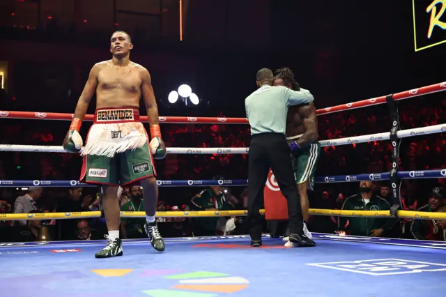 David Benavidez walks aways as the referee helps Anthony Yarde