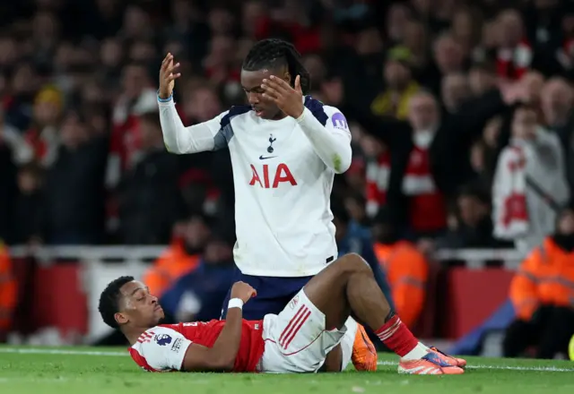 Arsenal's Jurrien Timber clashes with Tottenham Hotspur's Destiny Udogie.
