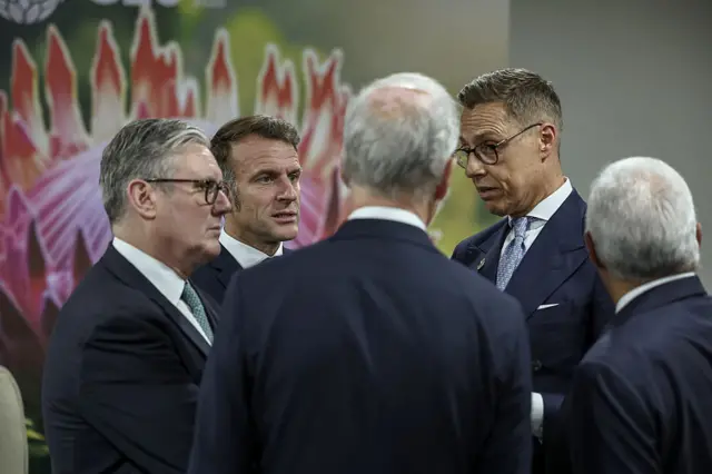 Britain's Prime Minister Keir Starmer (L), France's President Emmanuel Macron (2nd L) and Finland's President Alexander Stubb (2nd R) talk in a huddle at the G20