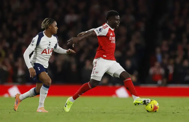 Tottenham Hotspur's Wilson Odobert in action with Arsenal's Bukayo Saka