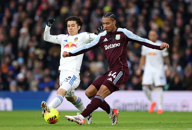 Boubacar Kamara of Aston Villa battles for possession with Ao Tanaka of Leeds United during the Premier League match between Leeds United and Aston Villa at Elland Road on November 23, 2025 in Leeds, England.