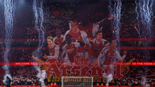 Arsenal fans display a tifo before the match