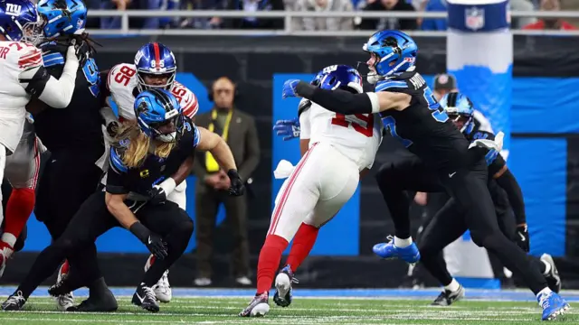 Jameis Winston of the New York Giants is sacked by defensive end Aidan Hutchinson of the Detroit Lions