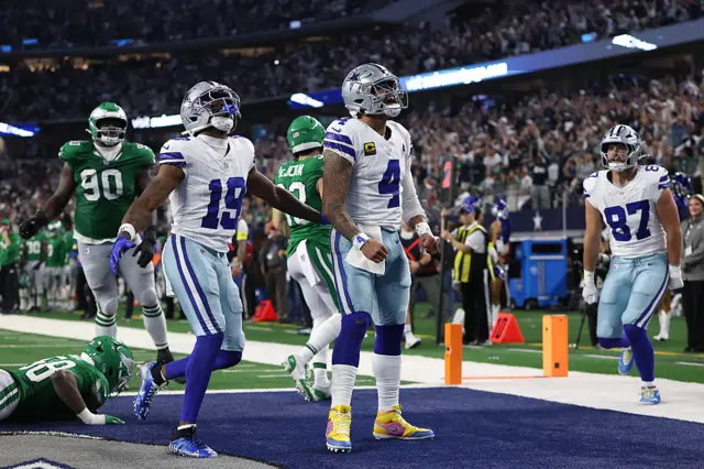 Dallas Cowboy players celebrate together after scoring a touchdown against the Eagles.