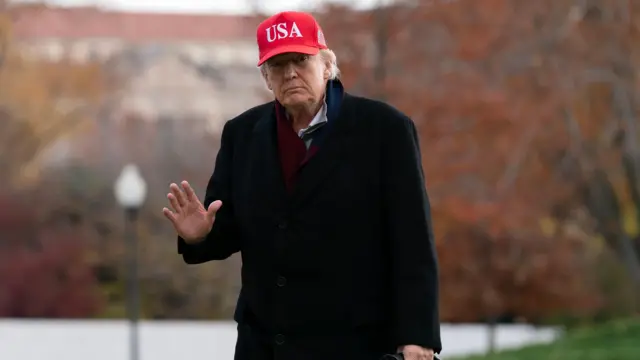 Donald Trump waves in USA hat