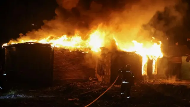 Firefighter putting out blaze in dark