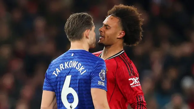 James Tarkowski of Everton clashes with Joshua Zirkzee of Manchester United