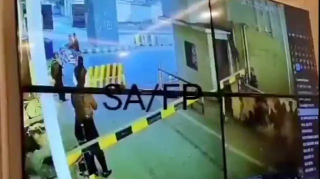 A video screengrab showing CCTV of the complex's gate prior to the explosion