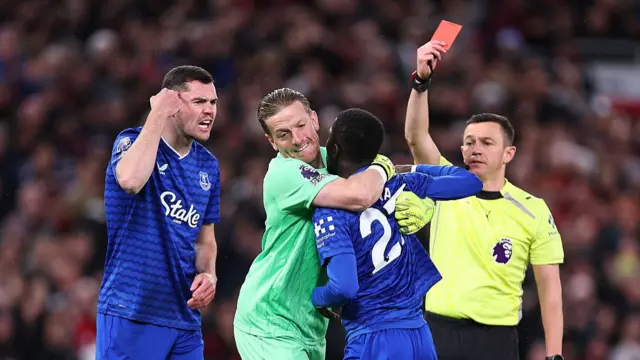 Idrissa Gueye of Everton receives a red card for a disagreement with Michael Keane