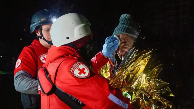 Man with emergency services having injury treated