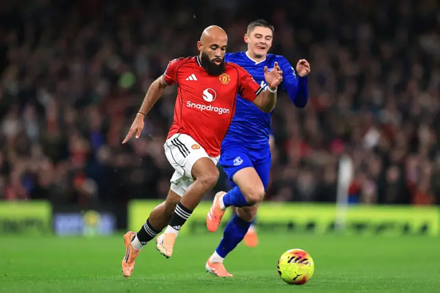 Bryan Mbeumo runs on the ball under pressure