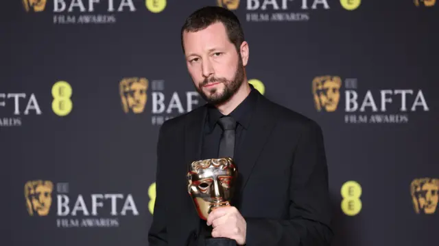 Mstyslav Chernov holds an Oscar