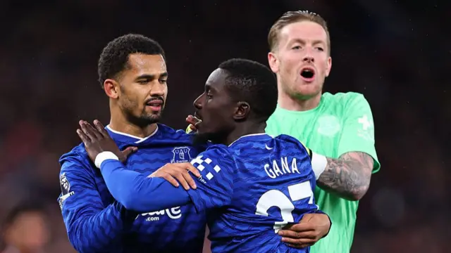 Idrissa Gueye of Everton is held back by his team-mates