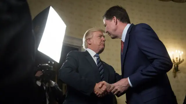 President Donald Trump, left, shakes hands with James Comey, director of the Federal Bureau of Investigation (FBI), during an Inaugural Law Enforcement Officers and First Responders Reception in the Blue Room of the White House in Washington, DC, US