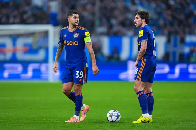 Bruno Guimaraes of Newcastle United talks with Sandro Tonali