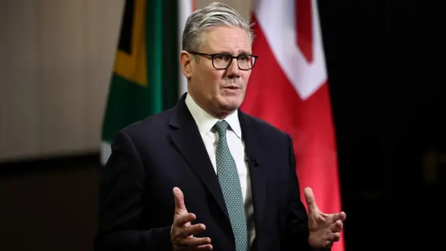 Prime Minister Keir Starmer gestures with both hands while talking