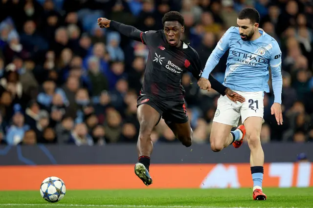 Ernest Poku of BayerLeverkusen and Ryan Ait-Nouri of Manchester City challenge