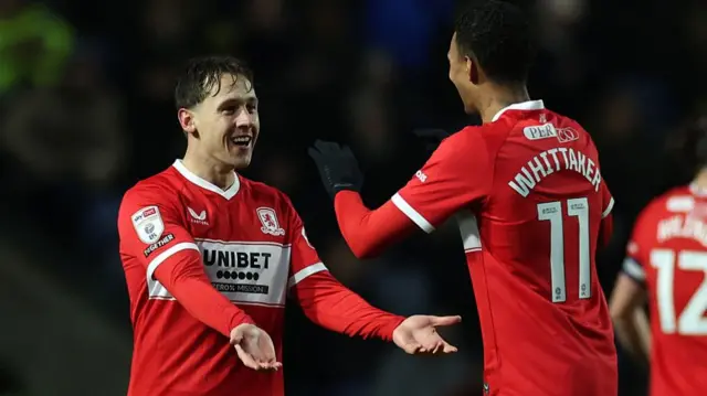 Callum Brittain embraces Middlesbrough goalscorer Morgan Whittaker