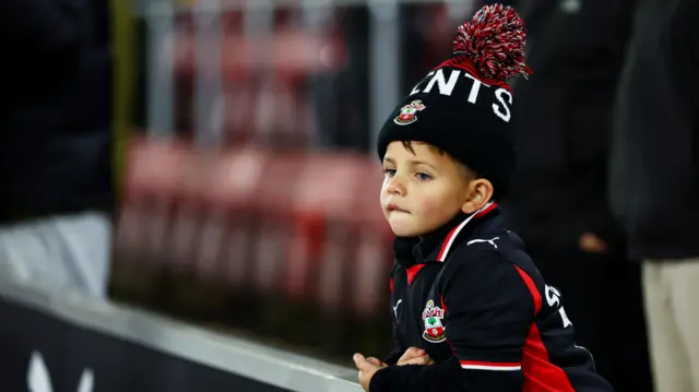 A young Southampton fan in a bobble hat at St Mary's