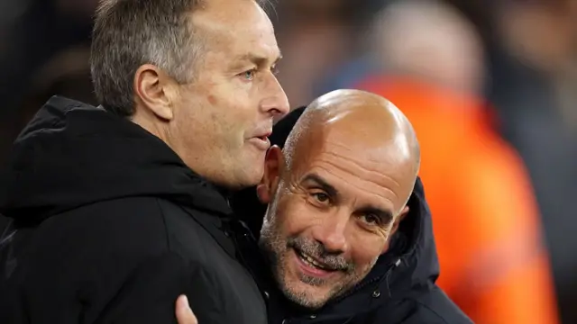 Pep Guardiola interacts with Kasper Hjulmand