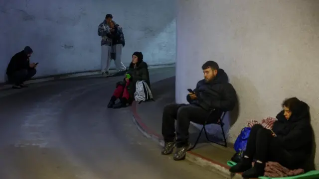 People take shelter inside an underground parking lot