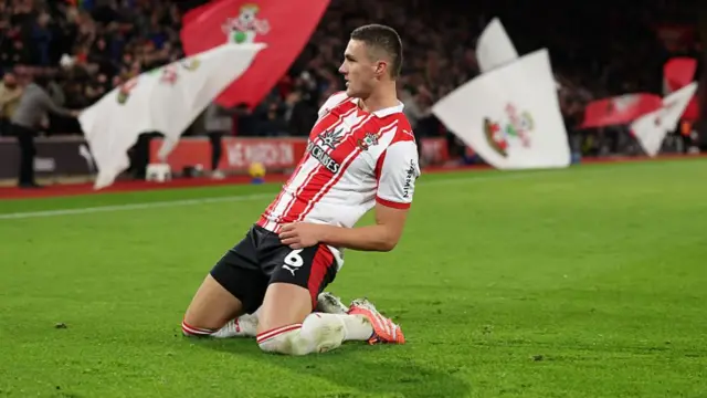 Taylor Harwood-Bellis slides on his knees in celebration