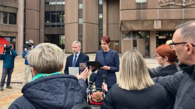 Scene outside court where police speak to press