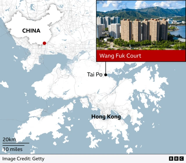 Alt text: Map showing the location of Wang Fuk Court in Tai Po, Hong Kong, with an inset photo of the tall residential buildings against a backdrop of green hills and water. An inset map show Hong Kong in the south east of China, with a red dot marking the area