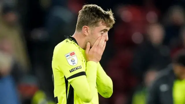 Pompey's Zak Swanson covers his face