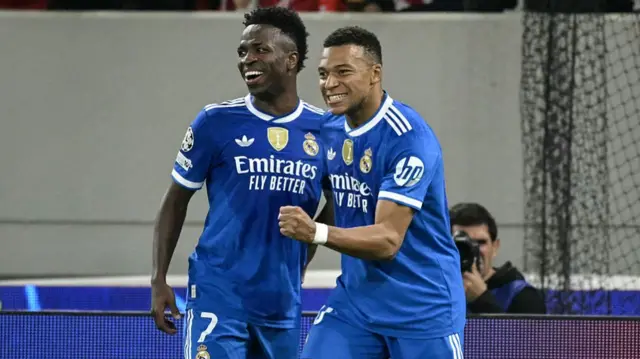 Kylian Mbappe (R) celebrates with Vinicius Junior (L)