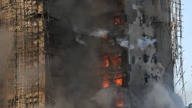 bamboo scaffolding along the burning high rise building