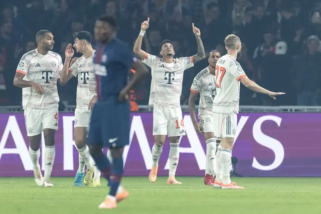 PSG players watch Bayern players celebrate
