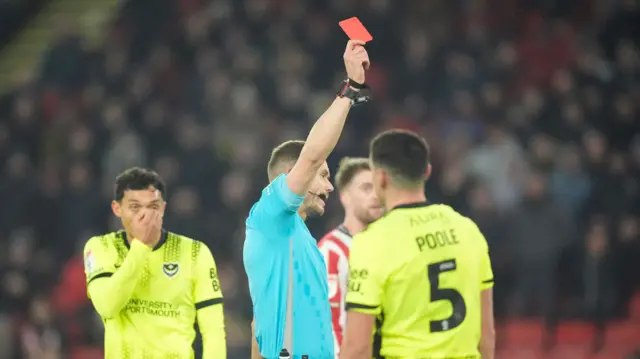 Terry Devlin is shown the red card