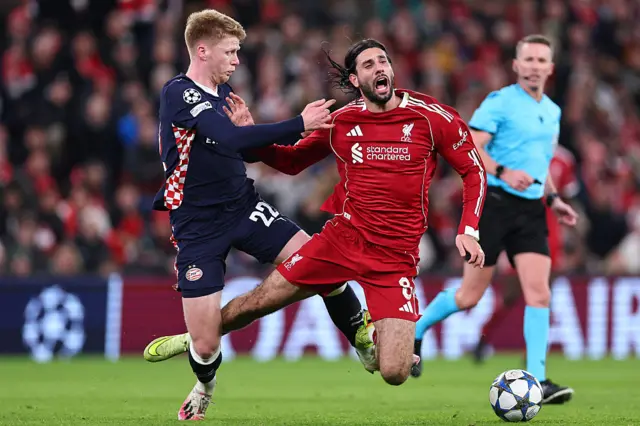Jerby Schouten of PSV tackles Dominik Szoboszlai of Liverpool
