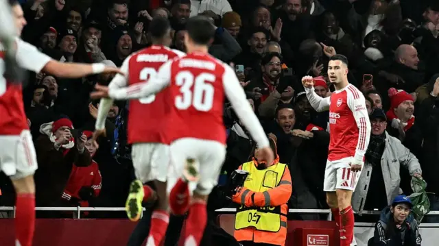 Gabriel Martinelli (R) celebrates scoring