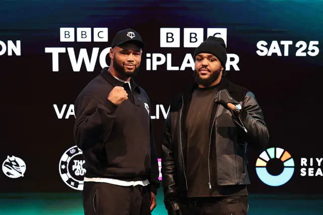 Frazer Clarke and Jeamie TKV hold up their fists to the cameras