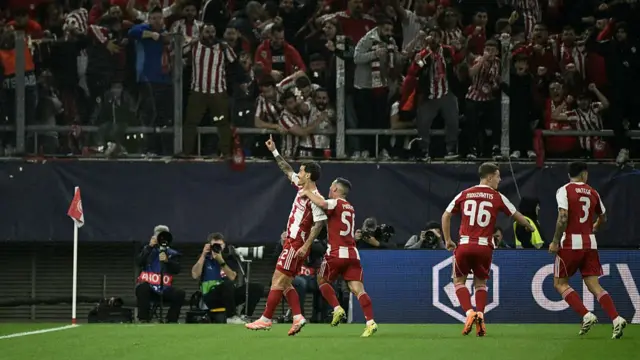 Olympiakos forward Chiquinho (L) celebrates after scoring