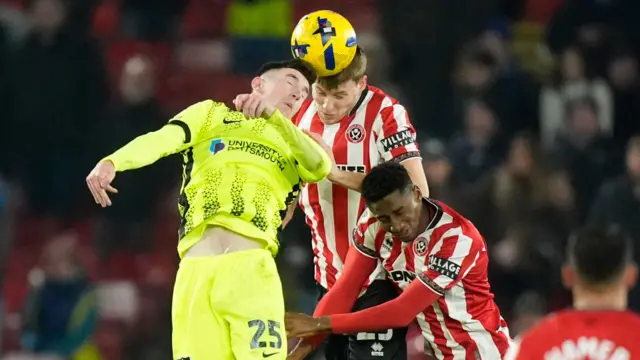 Portsmouth's Makenzie Kirk (left) battles for the ball with Sheffield United's Mark McGuinness (centre) and Djibril Soumare (right)