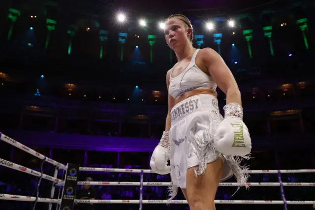 Francesca Hennessy in the ring in an all white outfit