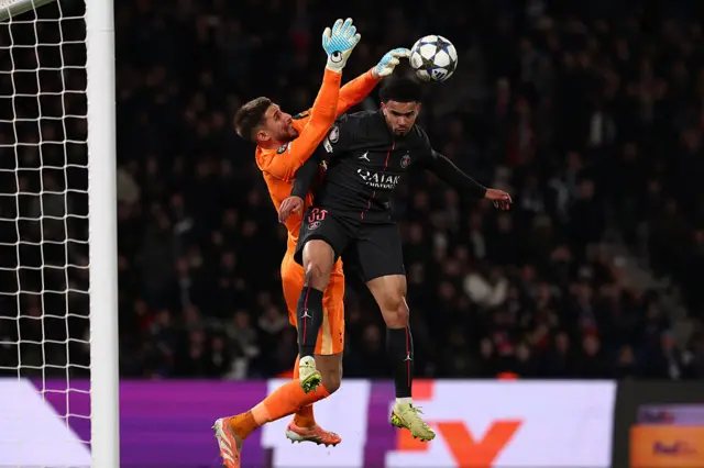 Guglielmo Vicario (L) saves an effort