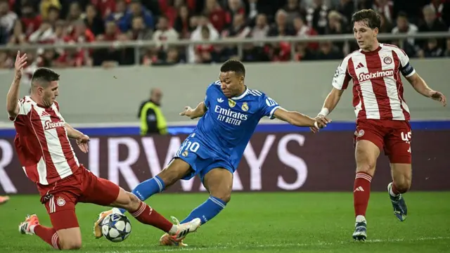 Kylian Mbappe (C) shoots to score his team's first goal