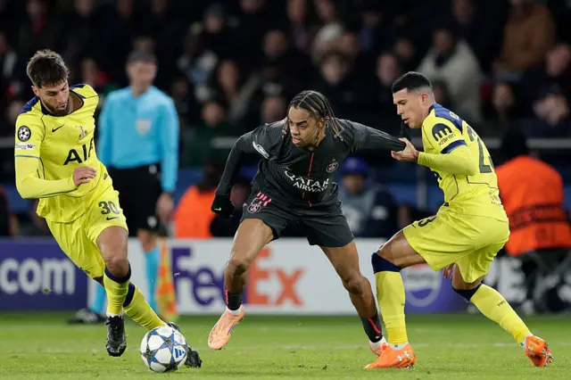 Rodrigo Bentancur, Bradley Barcola and Pedro Porro tussle for the ball