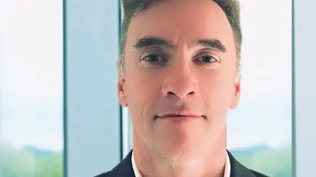 Paul Doyle, a man in his 50s wearng a suit.