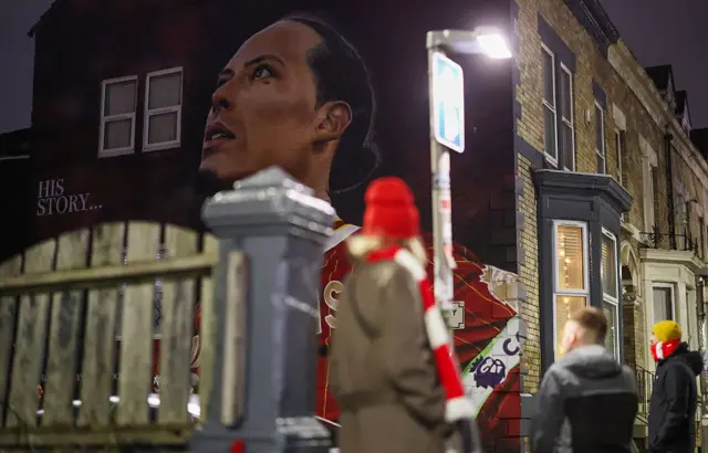 Virgil van Dijk's mural with Liverpool fans looking at it