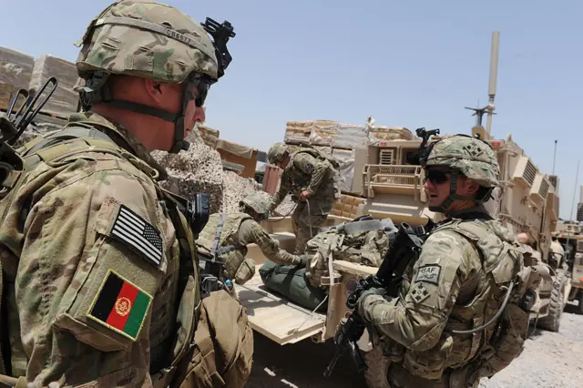 US troops from the Combined Task Force Dealer 1-67 Armored Battalion in full uniform prepare a convoy of Mine Resistant Ambush Protected Vehicles for a patrol mission