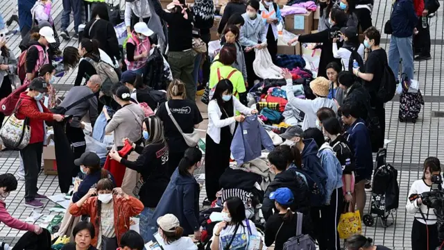 Volunteers sorts out donated clothes