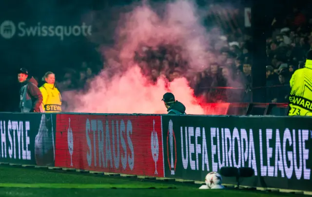 A firework by the side of the pitch after Feyenoord's first goal