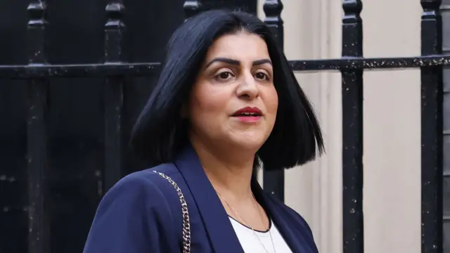 Home Secretary Shabana Mahmood wearing a navy blue blazer and holding a blue diary as she arrives at Downing Street