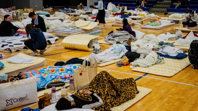 Image showing people sheltering in a community hall acting as an emergency shelter after the apartment fire in the Tai Po
